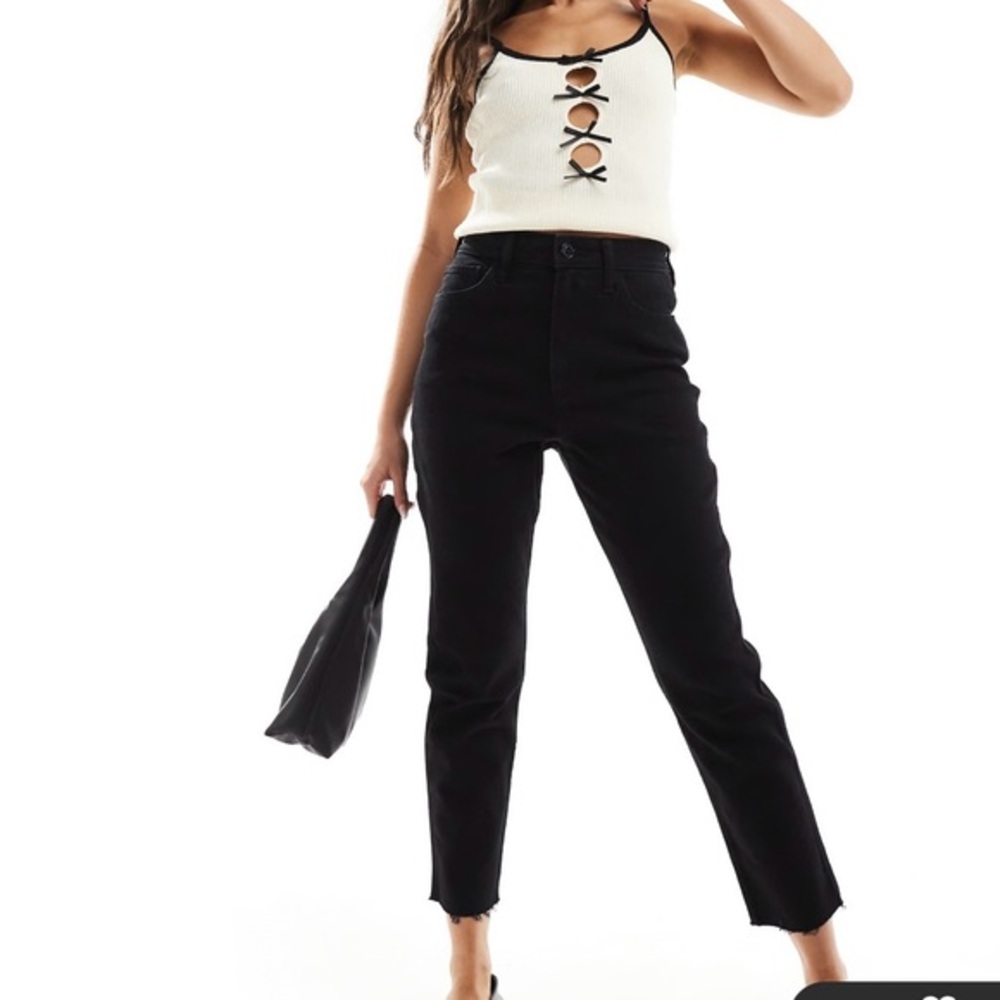 Hollister high rise mom jean in black denim, raw leg bottom. 23 X 25.